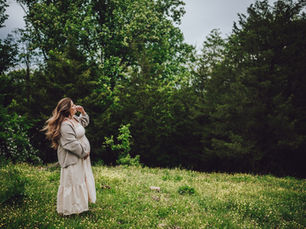 expecting mother stand in wildflower field in Southern Indiana