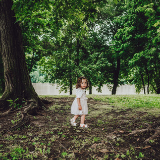 Little girl stands in the trees during family photoshoot in Madison Indiana