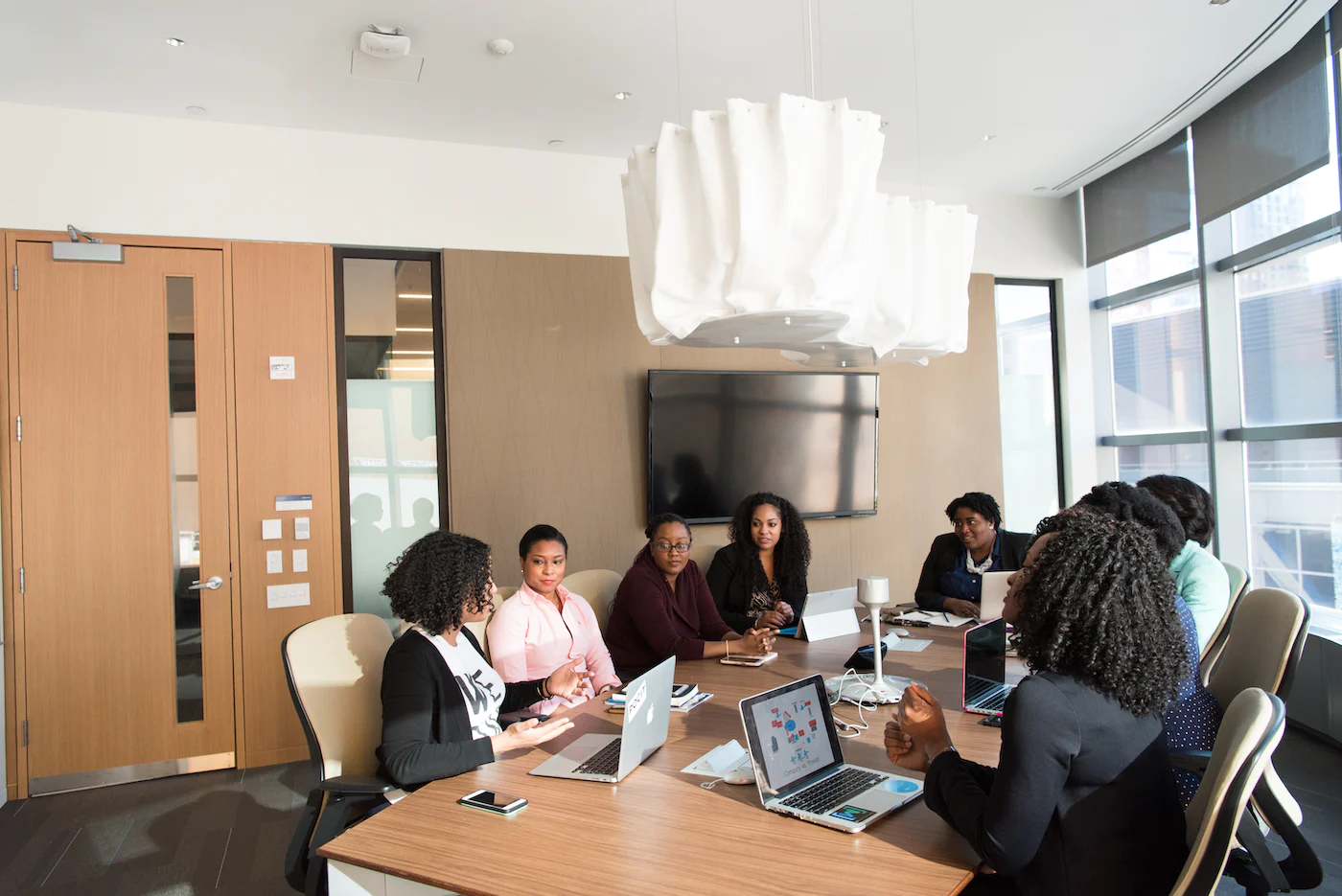 A group of professional black people in a boardroom.