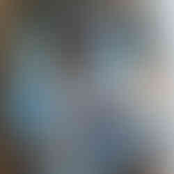 Rolled up mouse pads with various designs in a cardboard box