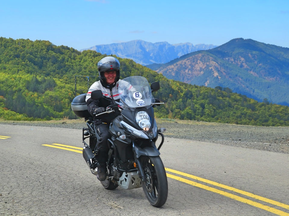 biker riding a motorcycle in the greek mountains