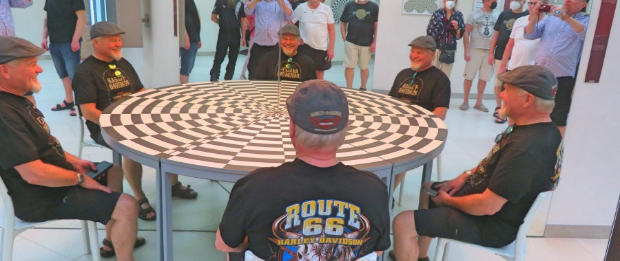 Fun at the Round Table, tourists sitting around illusion table