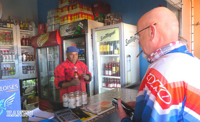 Biker buying drinks in a small shop in Morocco on his Peterpanplanet motorcycle tour