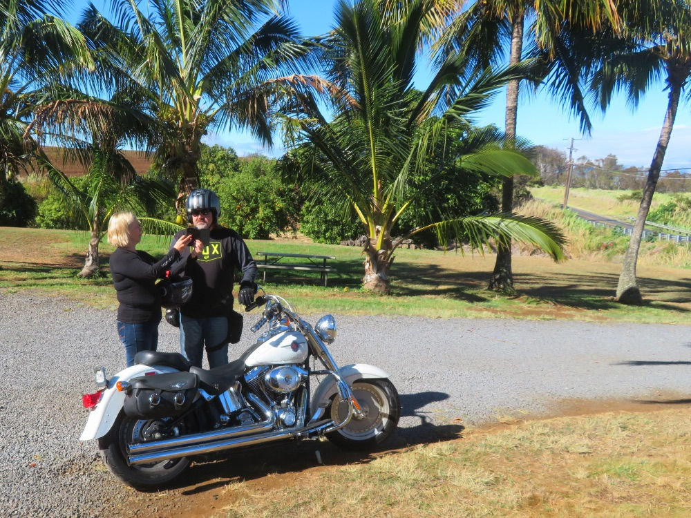 Bikers couple and white Harley Davidson motorcycle in Maui on a Peterpanplanet motorcycle tour