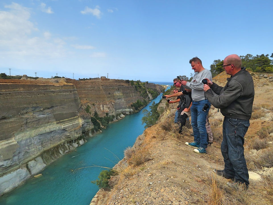 men above Corinth canal taking photos