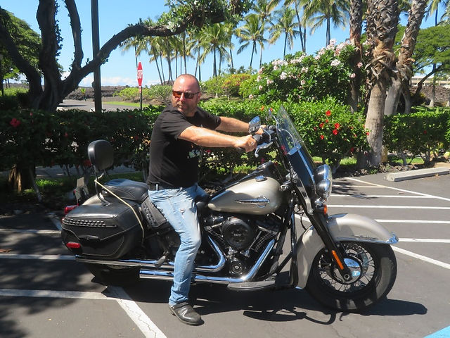 Harley Biker sitting on motorcycle in Big Island in Hawaii, on the Peterpanplanet motorcycle tour Aloha