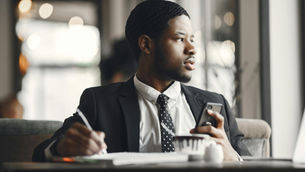 Focused professional preparing a job application with notes and a laptop
