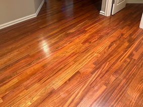 Refinished Brazilian Cherry hardwood floors restored with the Bona floor finishing system featuring rich warm tones and restored natural wood grain.