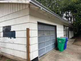 Freshly painted Portland home exterior featuring Sherwin-Williams Iron Ore siding during a full investor renovation and exterior refresh.
