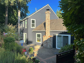 Luxury Lake Oswego home exterior painted in Benjamin Moore Abyss with a dark charcoal finish and modern Pacific Northwest aesthetic.