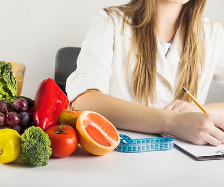 dietician-s-hand-writing-clipboard-with-