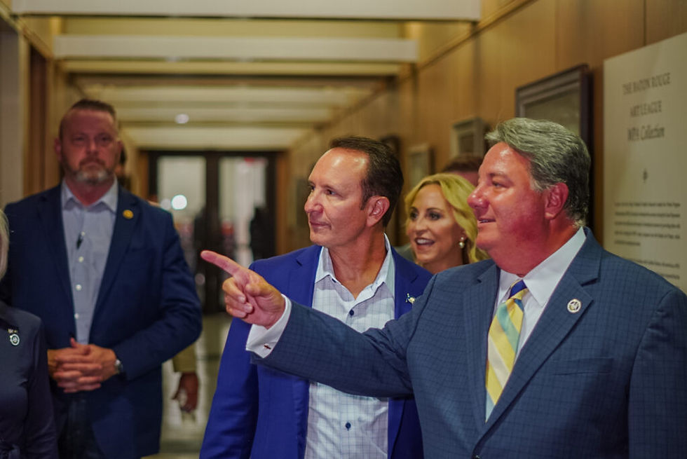 Secretary of State Kyle Ardoin, right, directs Attorney General Jeff Landry through the State Archives building prior to Landry qualifying for the Louisiana governor’s race Aug. 9, 2023. (Matthew Perschall for Louisiana Illuminator)