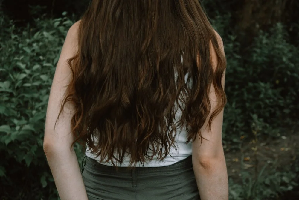 woman with long brown curly hair