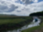 A beautiful view from Laugharne Castle, Pembrokeshire. River with boat. Sky. AvVida.co.uk