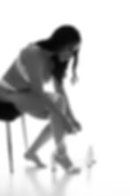 Woman in white lingerie tying her wedding shoes in calgary bodoir studio.