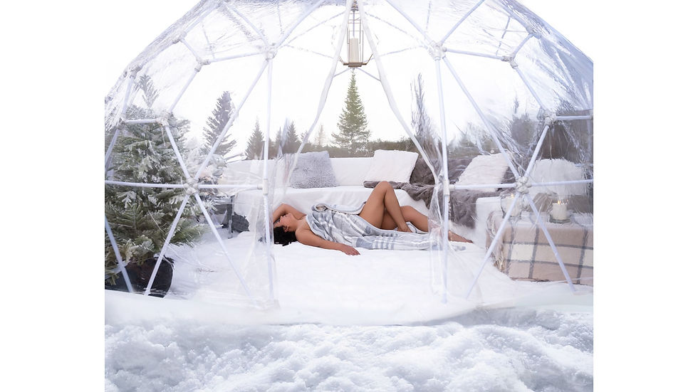 Woman posing inside a luxury rooftop igloo for winter boudoir photography in Calgary