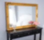 Luxury boudoir photography studio in Calgary, showcasing a white bedroom suite and gold vanity mirror.