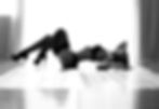 black and white boudoir photo of woman silhouette arching her back by Calgary boudoir photographer.