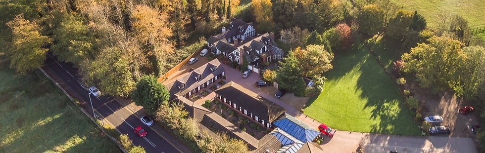 A birdseye view photograph of the hotel site and surrounding greenery and farmland.