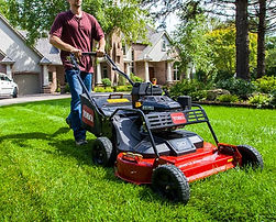 Professional lawn mowing in Etobicoke by Clover Property Care using a Toro mower for clean, even grass lines.