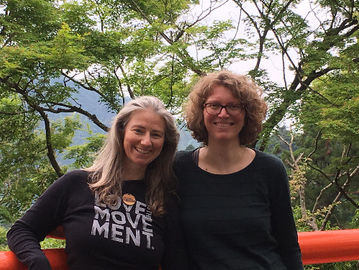 Amanda Jayne and Silke Kleemann, authors of Women in Reiki, standing on Mount Kurama with trees and mountains in the background