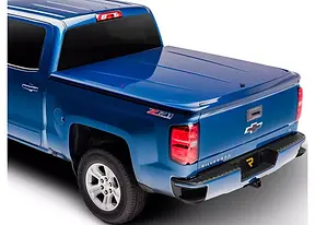 Blue Chevrolet Silverado with a closed color-matched painted tonneau cover
