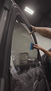 Technician applying window tint.