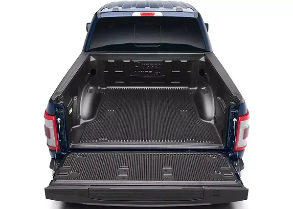 Overhead view of a black drop-in bed liner covering a pickup bed and tailgate.