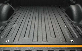 Close-up of a pickup truck bed coated with black LINE-X Standard spray-on bedliner.