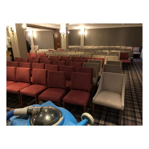 rows of wedding venue chairs during cleaning