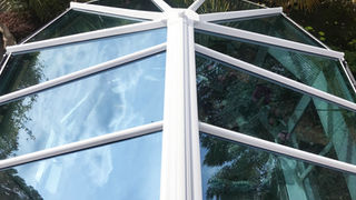 Conservatory roof exterior white frame tinted glass

