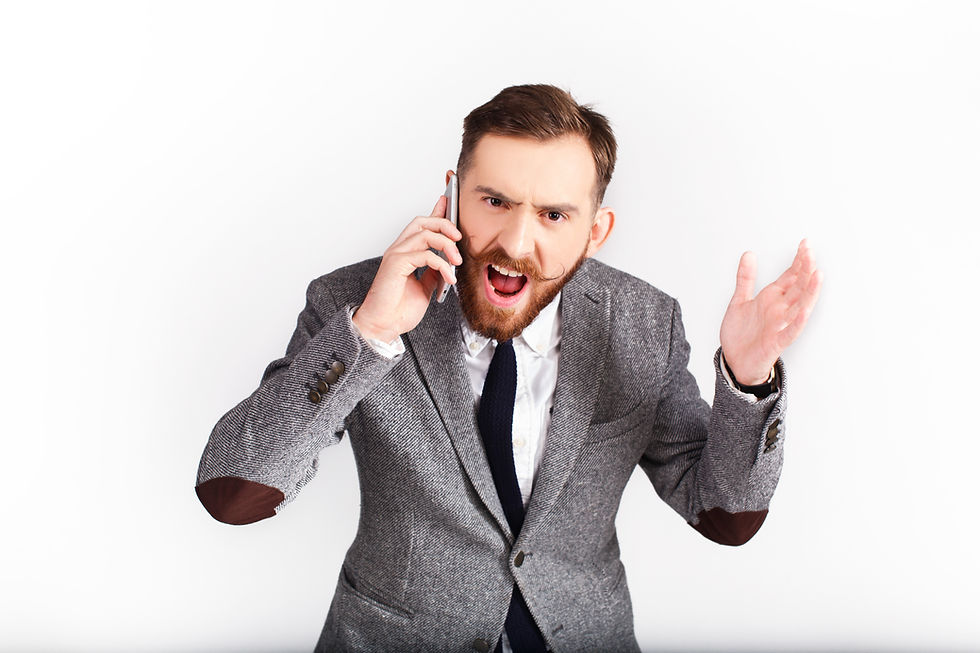 Cold call recipient speaking angrily on the phone while gesturing with one hand