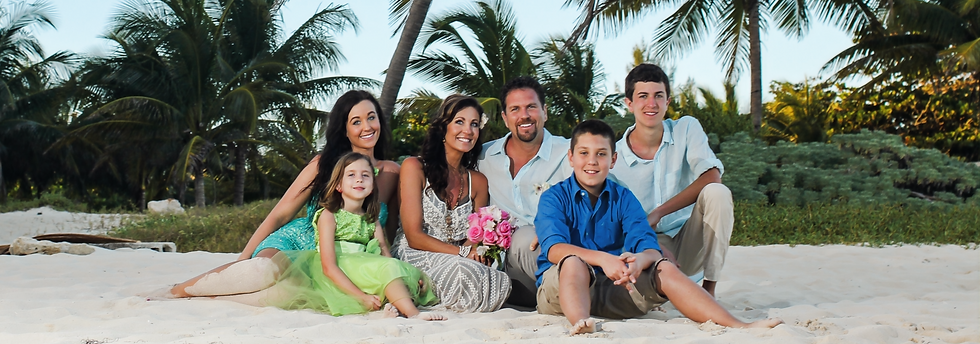 A couple and their children celebrating their vow renewal in Cancun