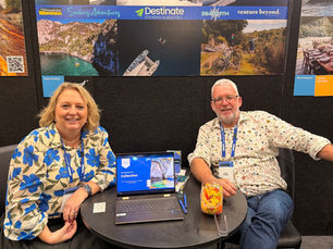 two people at a tradeshow selling their tourism experiences