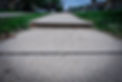 Raised sidewalk section in a suburban neighborhood creating a tripping hazard
