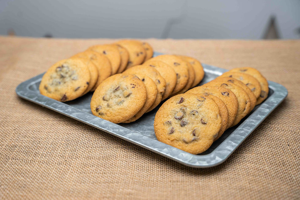 A metal tray full of chocolate chip cookies