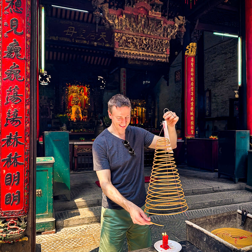 James lighting a gigantic incense coil for good luck at Tue Thanh Assembly Hall in Ho Chi Minh City, Vietnam.