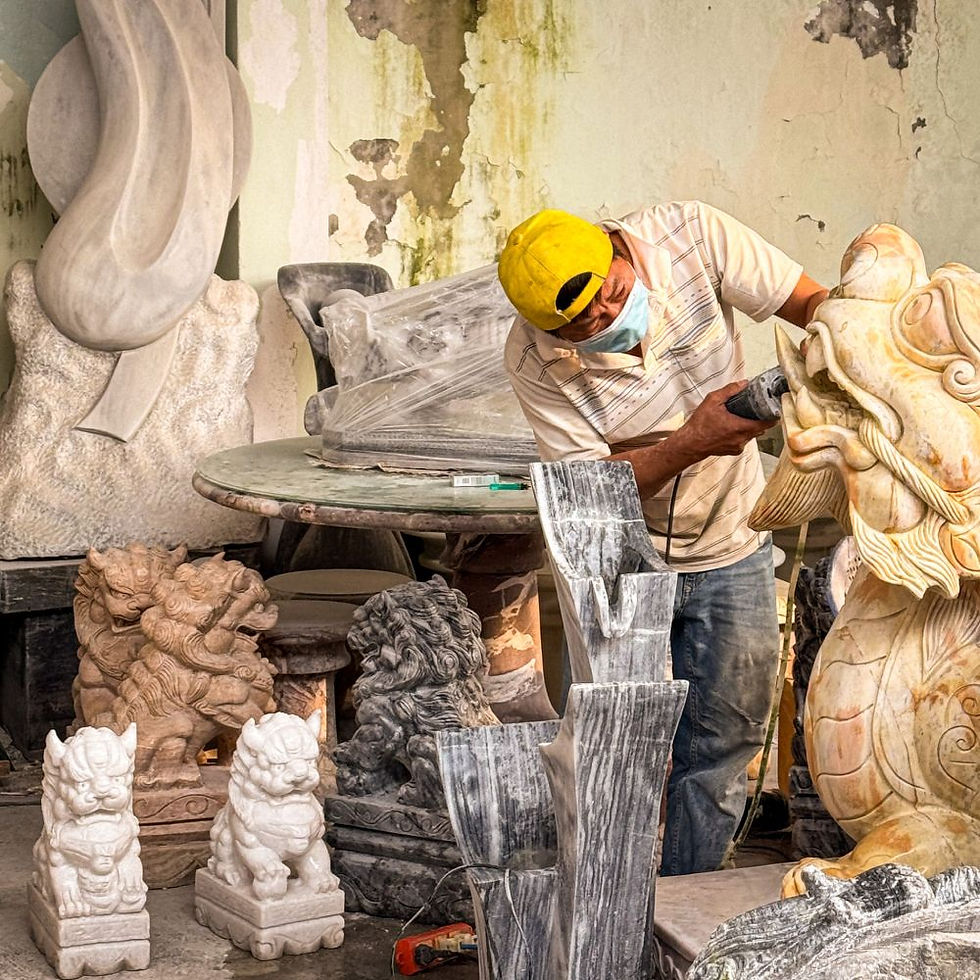 Marble artisan at work at a family-owned studio in the Marble Mountains