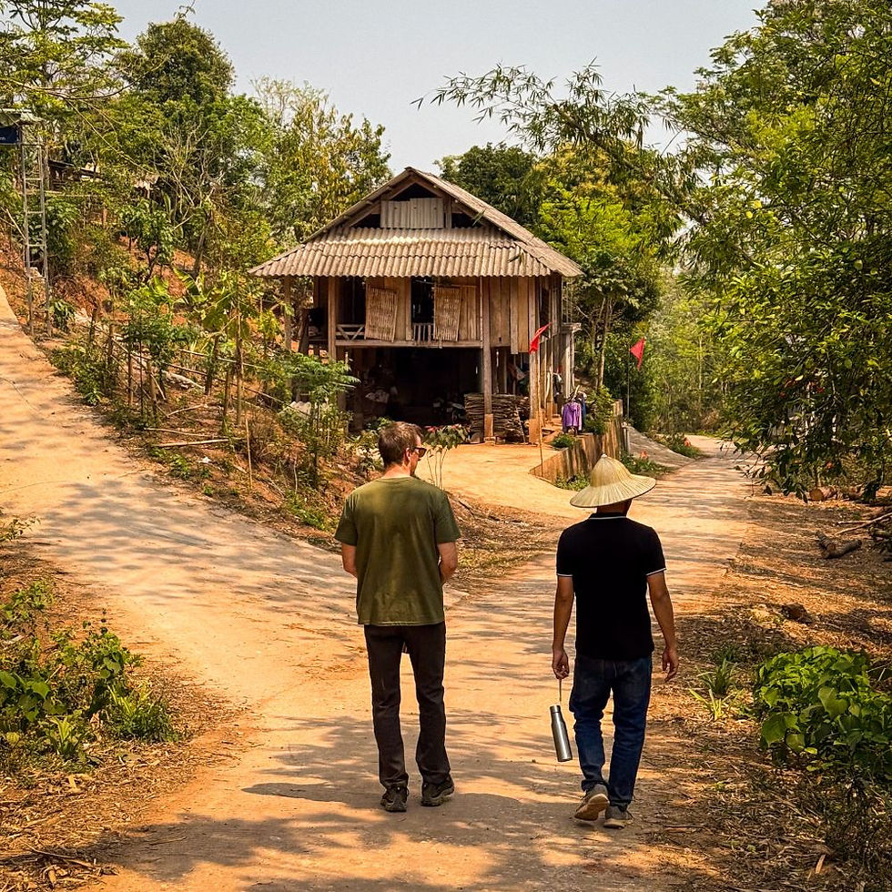 James and our guide walking through Co Cham, a tiny community we visited with one dirt road, 35 families, and a daily rhythm dictated by the sun, the seasons, and the occasional wandering cow.