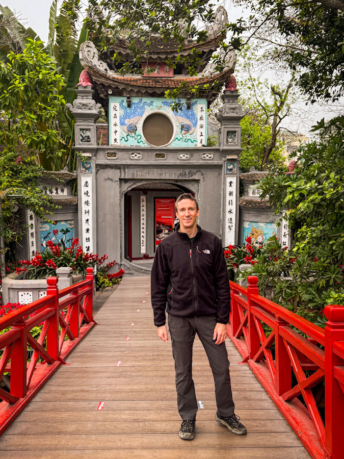 James making his way across Thê Húc Bridge like a man on a mission — destination: Ngoc Son Temple, legends, and maybe a turtle sighting. This scarlet stunner looks like it waltzed straight out of a lacquer painting, but don’t forget: tickets first, temple second!