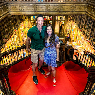 James & Shal on the iconic red staircase at Livraria Lello.
