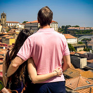 Shal & James in an embrace looking out at the sweeping view of Porto below.