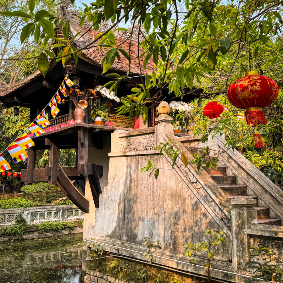 The very photogenic One Pillar Pagoda - snapping a photo framed by foliage is a must-see on your list for things to do in Hanoi.
