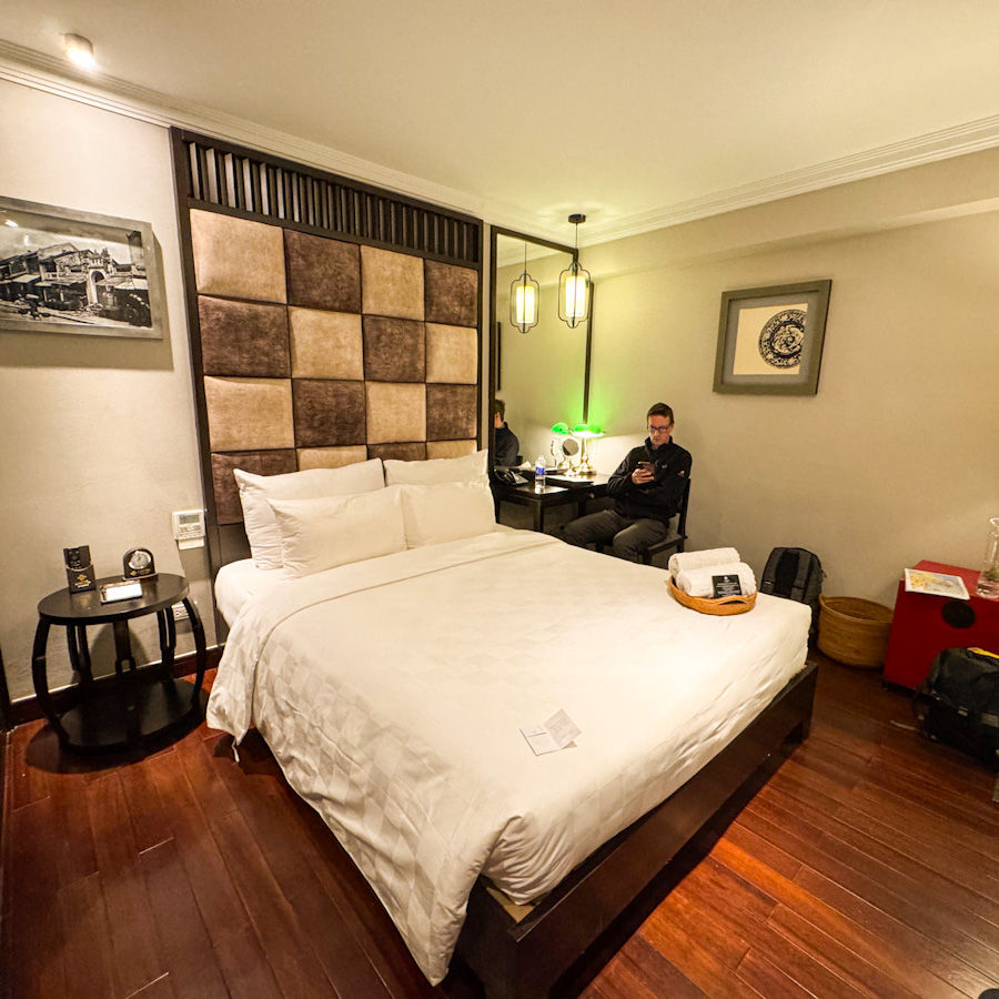Our "deluxe" room at L'hotel du Lac in Hanoi: One chair (which James is making the most of), internal window, and somehow… still lovely enough for £65 pn?