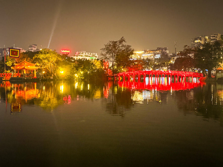 Reflections after dark of Thê Húc Bridge leading to Ngoc Son Temple in Hoan Kiem Lake.