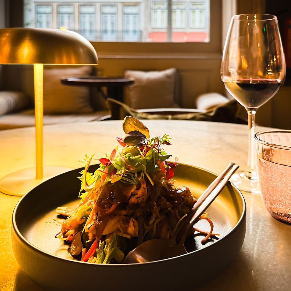 Porto travel tips: Make restaurant reservations ahead of time to dine on beautifully plated food piled high with chopsticks, red wine and a vintage table lamp at hotspots