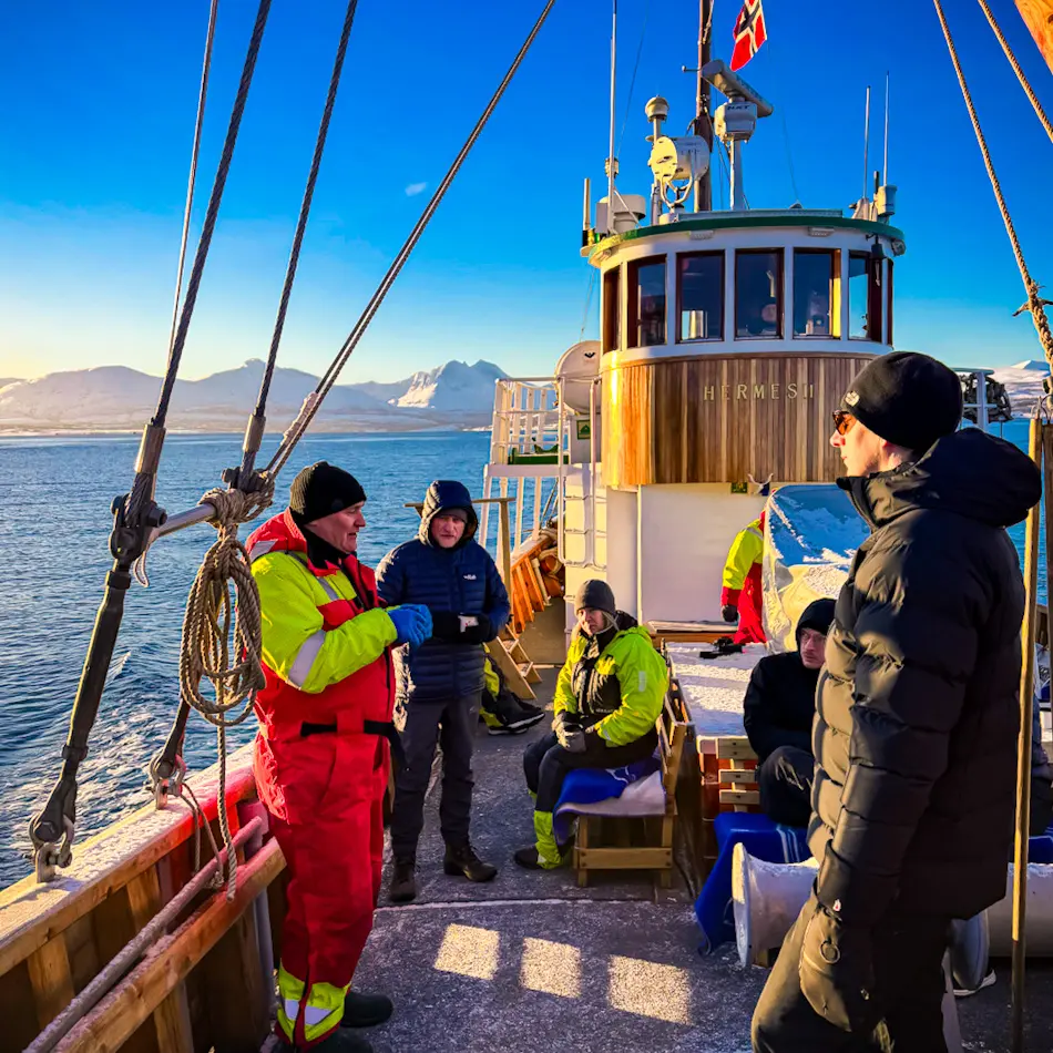 Passengers aboard the historic Hermes II during a fjord cruise on a Tromso itinerary.