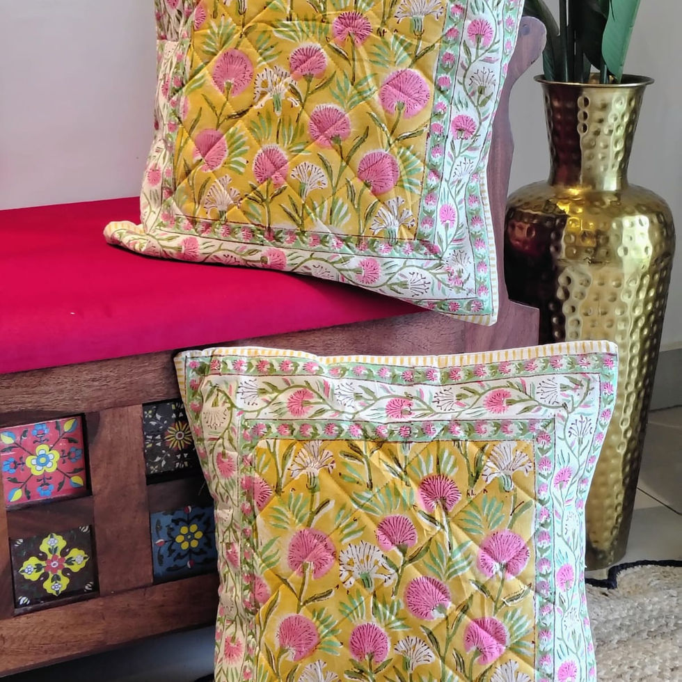 Handcrafted quilted cotton cushion covers with block-printed patterns and textured detailing.