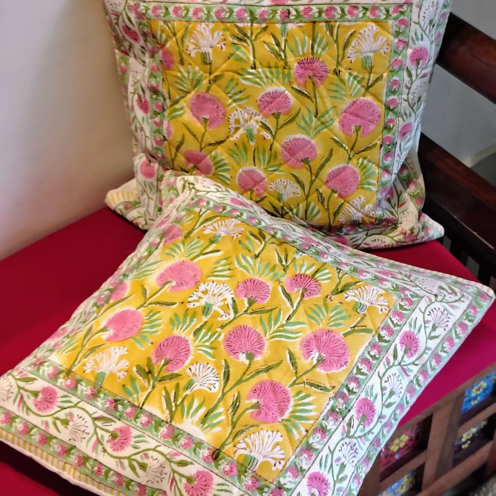 Handcrafted quilted cotton cushion covers with block-printed patterns and textured detailing.