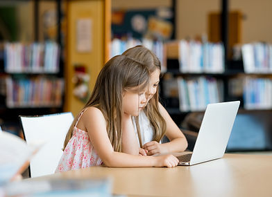 Girls in library on laptop with logo large.jpeg